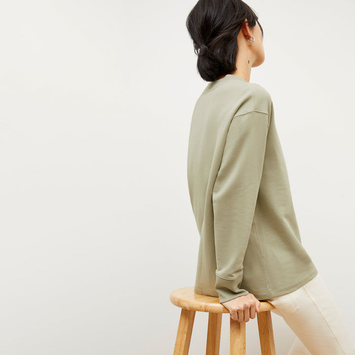 Back image of a woman wearing the Ellie Pullover - Light French Terry in Laurel Green