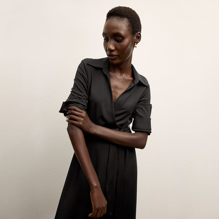 front image of a woman wearing the emmett dress in black