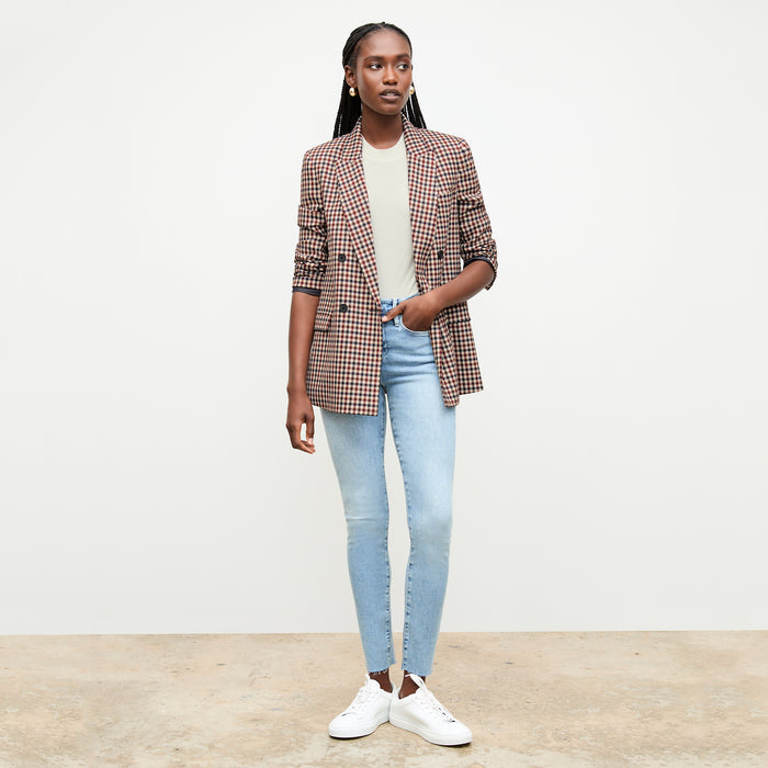 front image of a woman wearing the frame denim le high skinny raw after jean in galeston | Lead