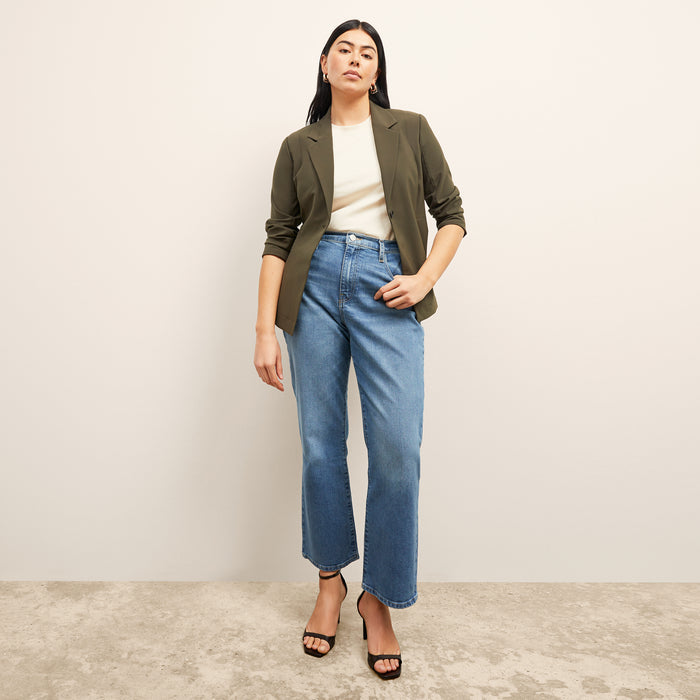 front image of a woman sitting wearing the frame le jane ankle jeans in deepwater | Lead