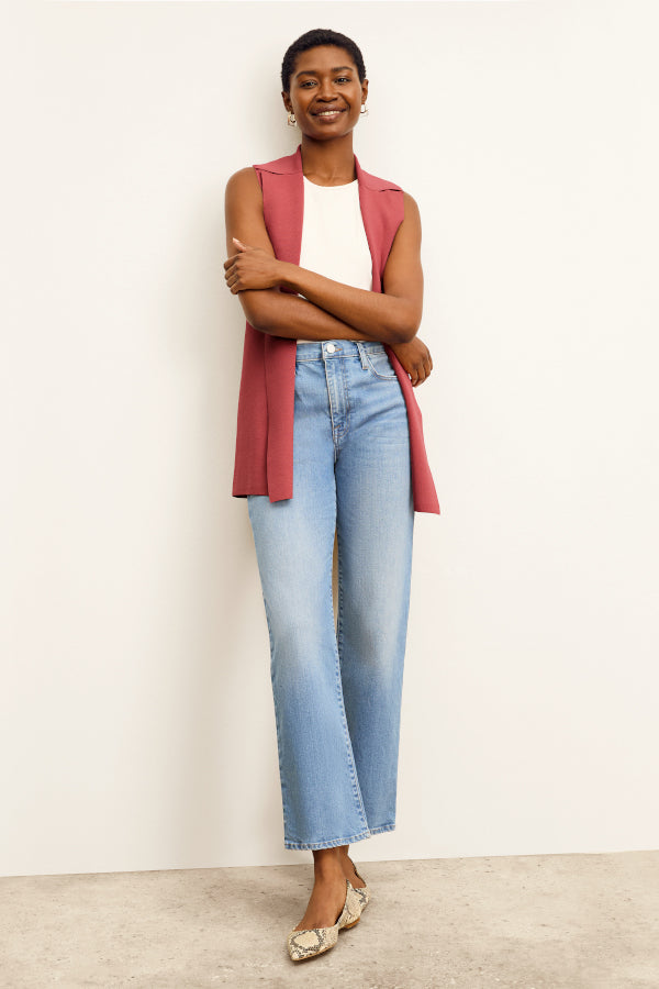 front image of a woman sitting wearing the frame le jane ankle jeans in deepwater | Exclude