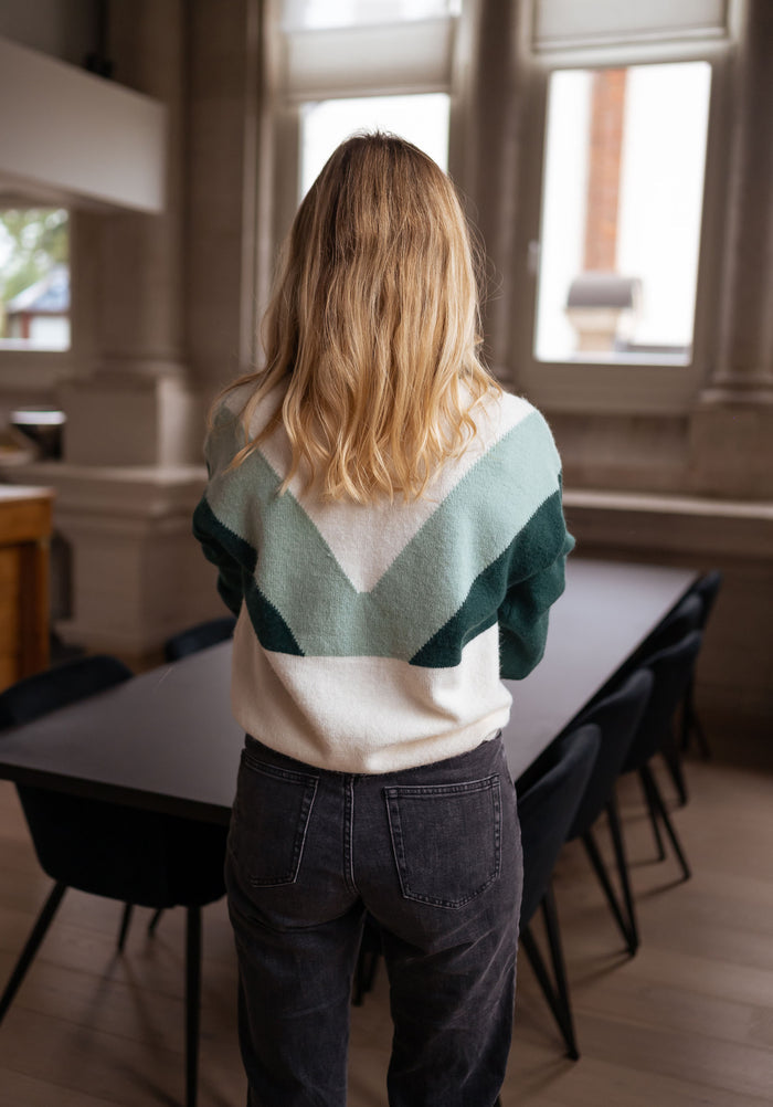 Green sweater high collar gold button detail