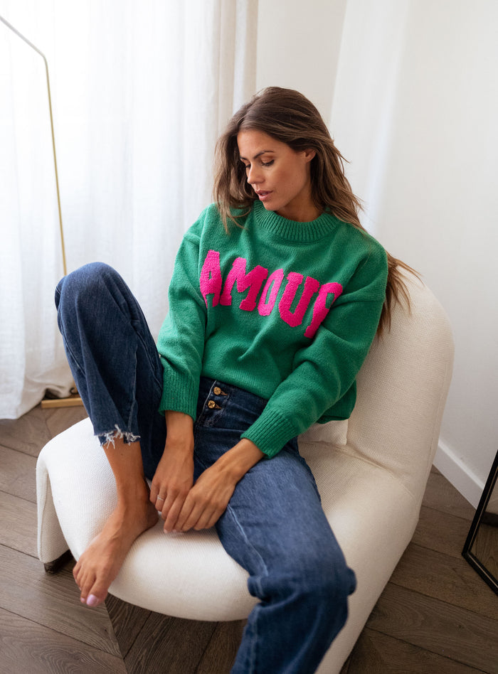 Green sweater pink lettering detail