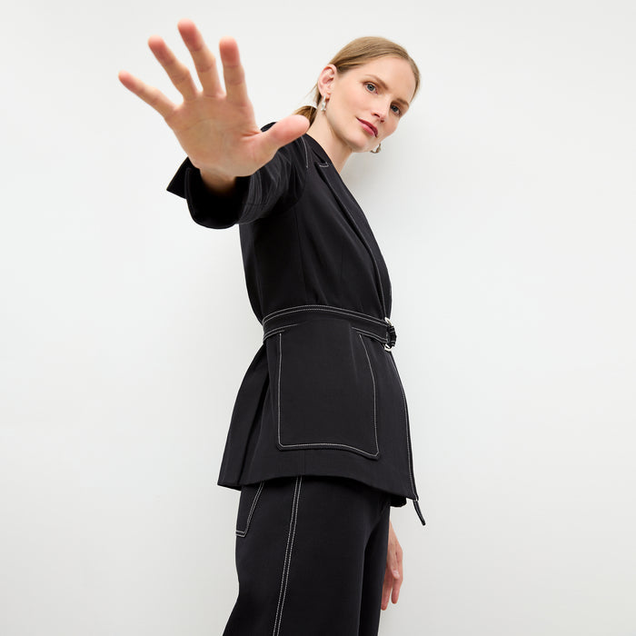 side image of a woman wearing the grenville jacket in black