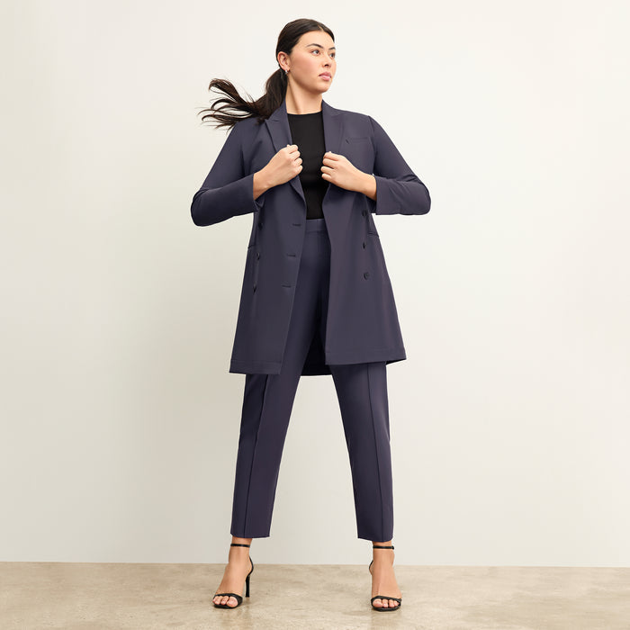 back image of a woman wearing the gwynne dress in cool charcoal