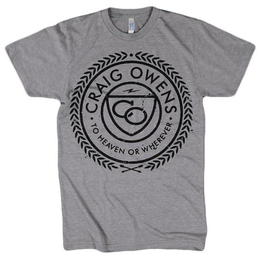 Craig Owens gray t-shirt with a circular black design, Craig Owens and To Heaven or Wherever text, a central stylized symbol, and laurel wreath accents around the circle.