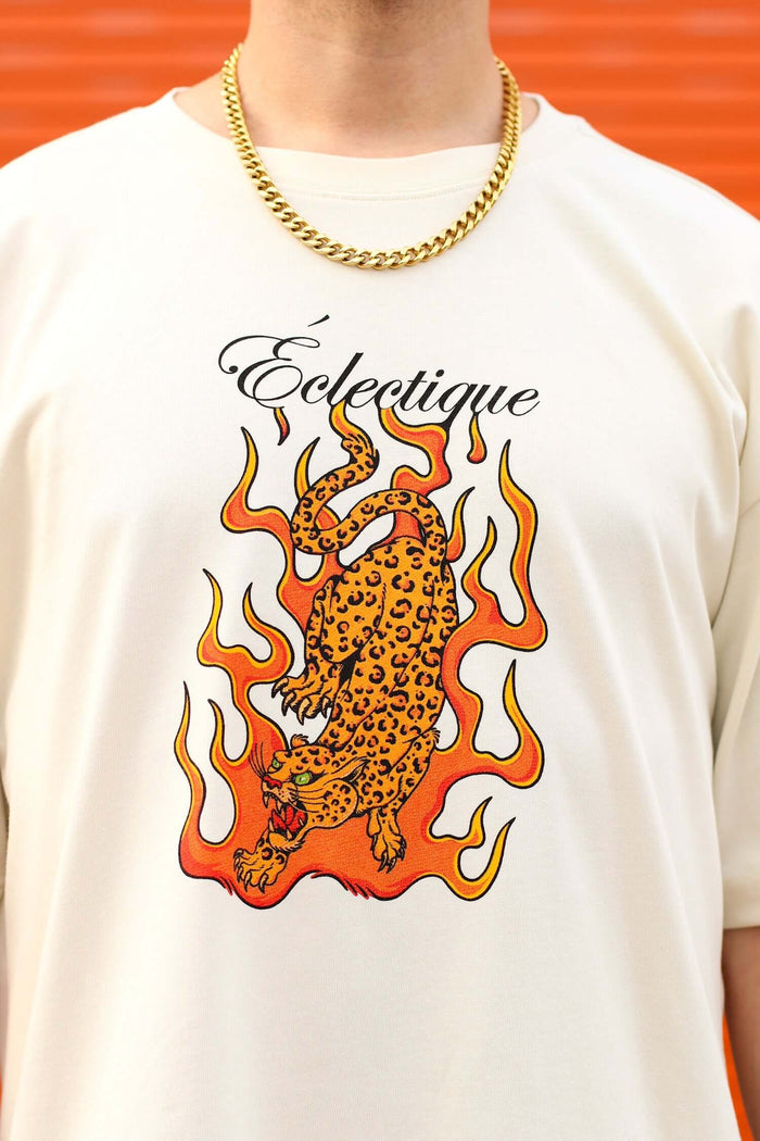 Jaguar Graphic T-shirt featuring flaming jaguar artwork and Éclectique branding on a cream background.