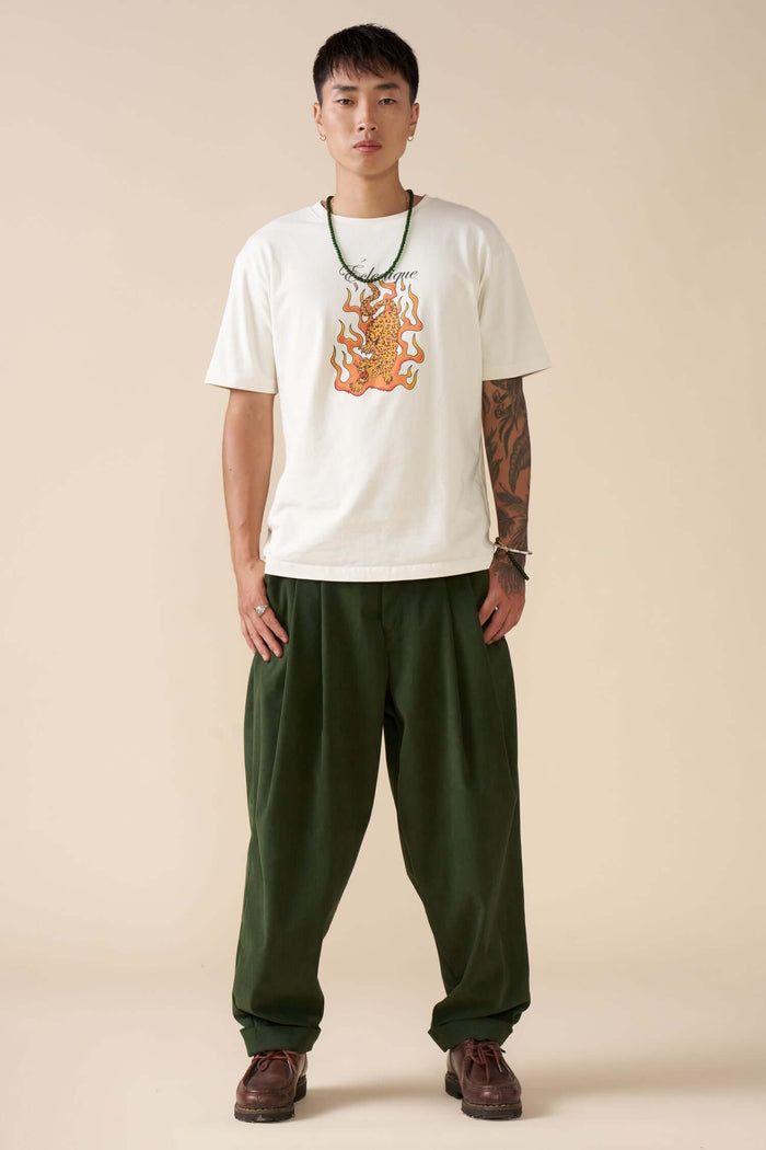 Model wearing Flaming Jaguar graphic T-shirt styled with green pants