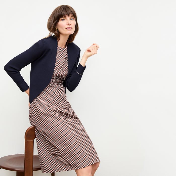 front image of a woman wearing the jeannine dress in windowpane sharkskin