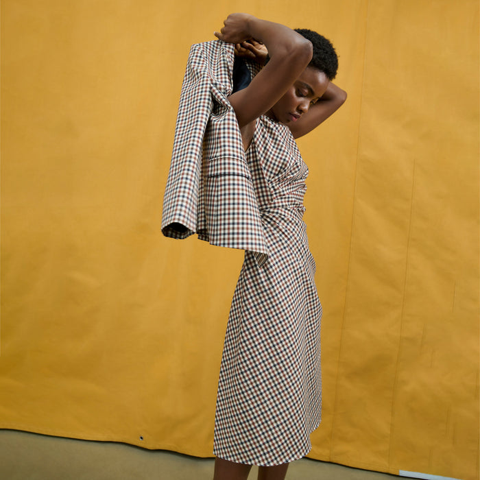 image of a woman wearing the jeannine dress in windowpane sharkskin