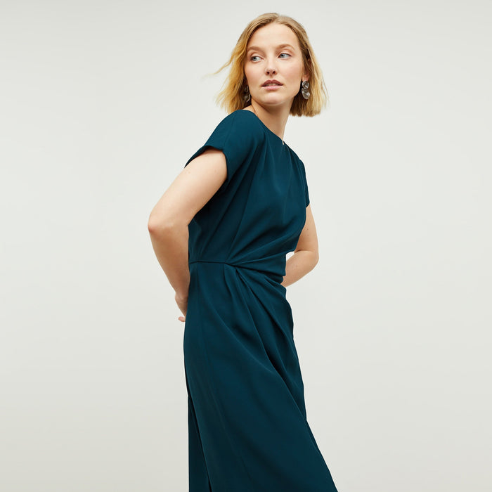 Side image of a woman standing wearing the Jillian Dress in Rainforest