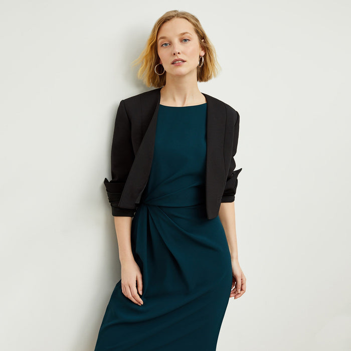 Front image of a woman standing wearing the Jillian Dress in Rainforest