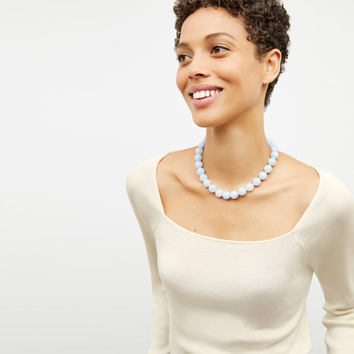 Detail image of a woman wearing the Joya Top in Cream