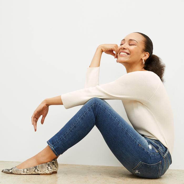 side image of a woman wearing the Joya Top in Cream