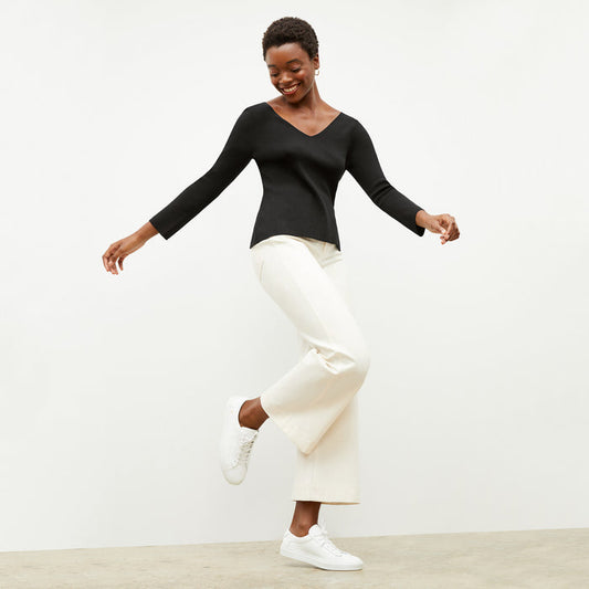 Front image of a woman wearing the kara top in black | Lead