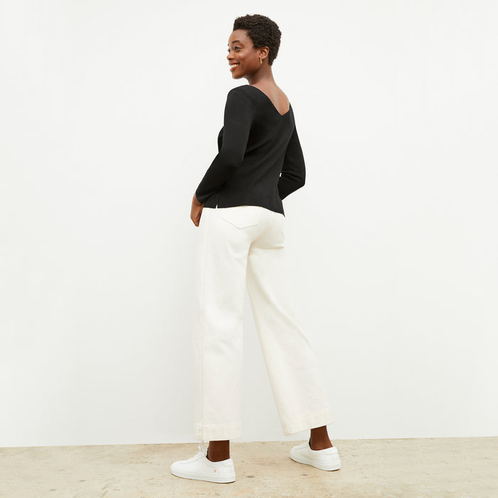 back image of a woman wearing the kara top in black