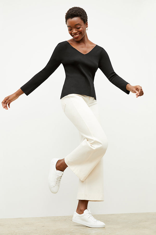 Front image of a woman wearing the kara top in black | Grid | Exclude