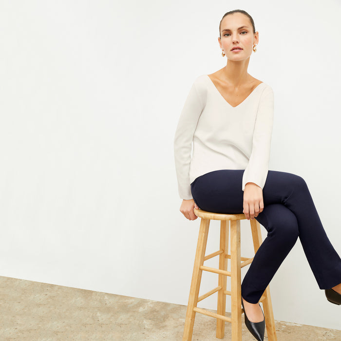 Front image of a woman wearing the kara top in ivory | Lead
