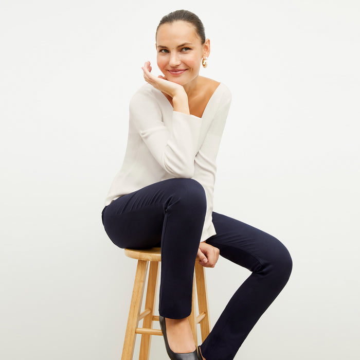 Front image of a woman wearing the kara top in ivory