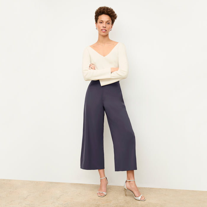 Front image of a woman wearing the kara top in ivory