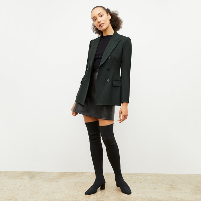 Front image of a woman wearing the kati jacket in forest