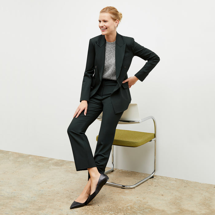 Front image of a woman wearing the kati jacket in forest