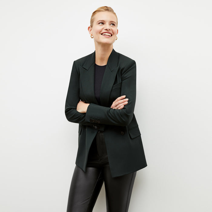 Front image of a woman wearing the kati jacket in forest