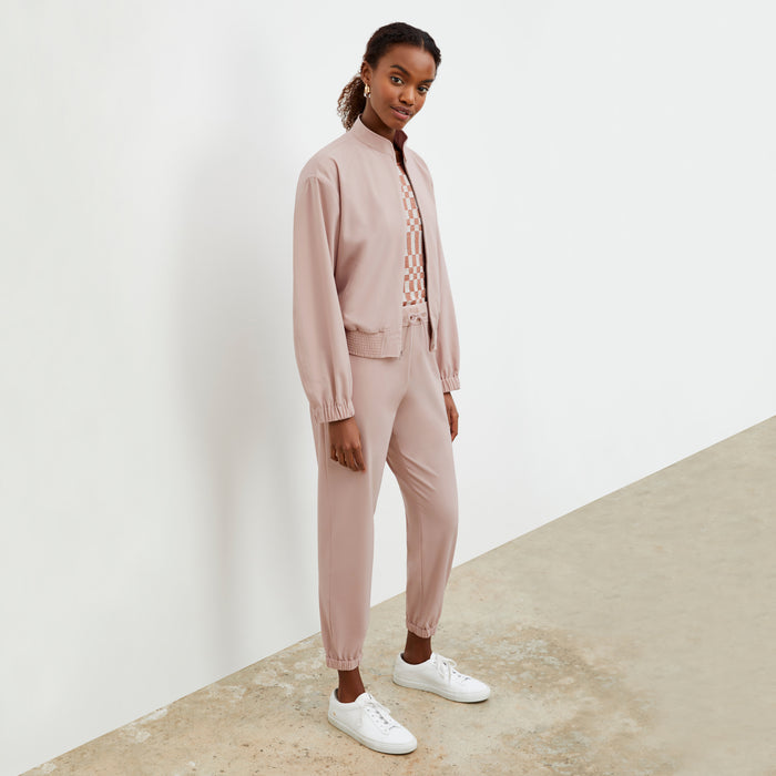Front image of a woman wearing the Langely Bomber in Origamitech in Blush | Lead