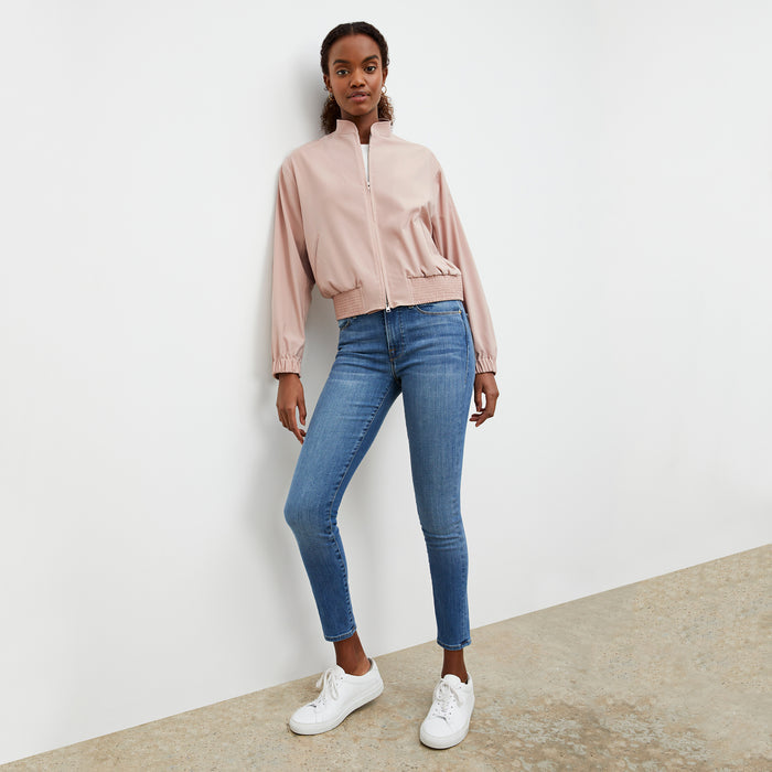 Front image of a woman wearing the Langely Bomber in Origamitech in Blush