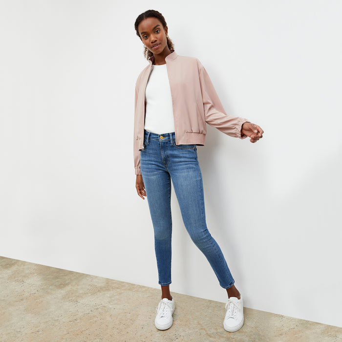 Front image of a woman wearing the Langely Bomber in Origamitech in Blush