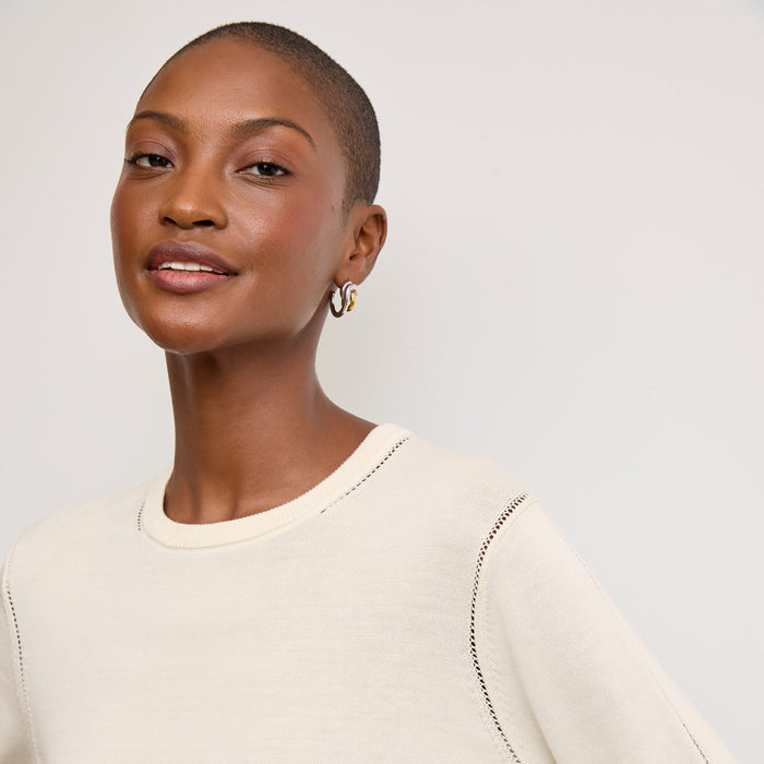 front image of a woman wearing the larissa sweater in ivory