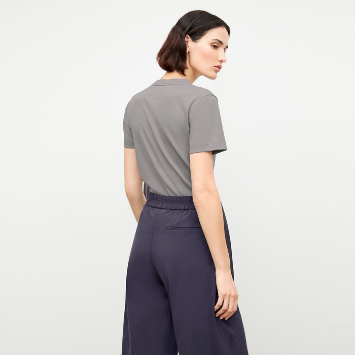 back image of a woman wearing the lee t-shirt in thistle