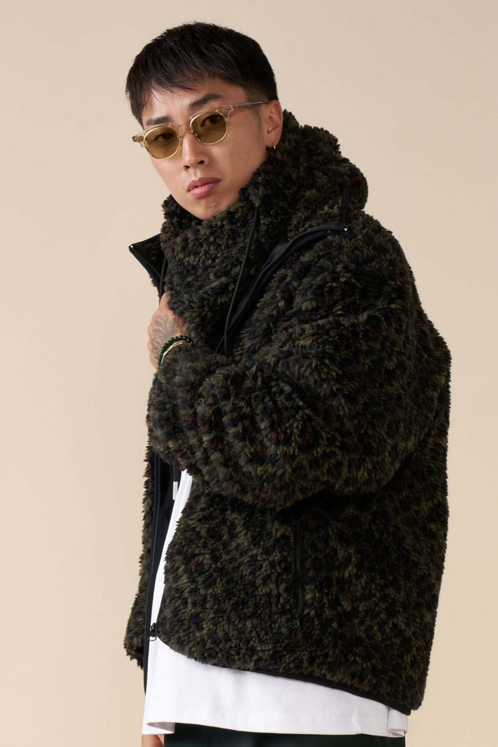 Side view of Éclectique leopard fleece balaclava styled with fleece jacket