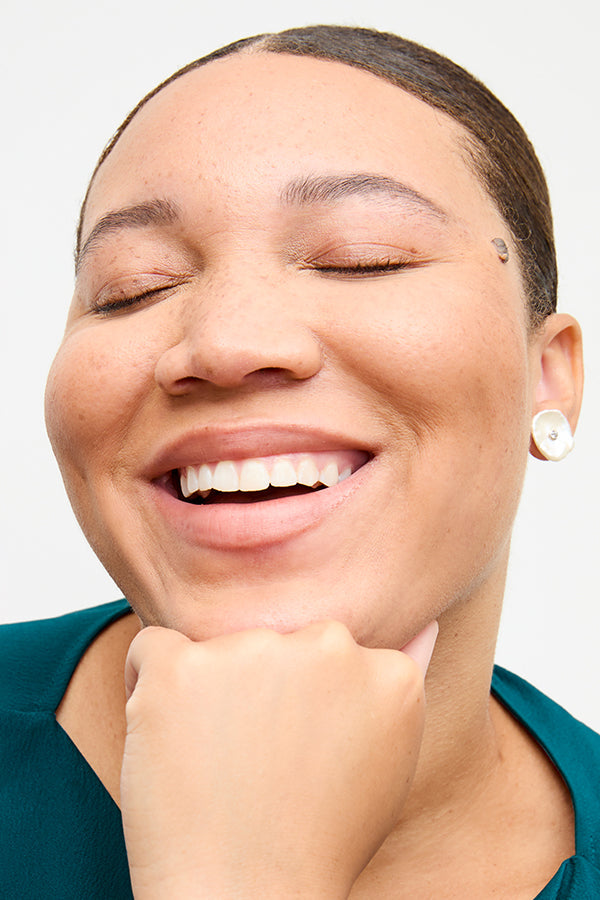 front image of a woman wearing the lillie earrings in pearl | Exclude | Grid Hover