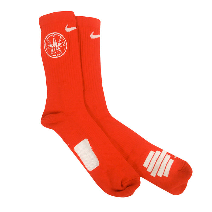 A pair of bright red City Rocks crew socks featuring a white logo near the top, a small white swoosh, and bold graphic designs on the lower part—available in youth and womens sizes.