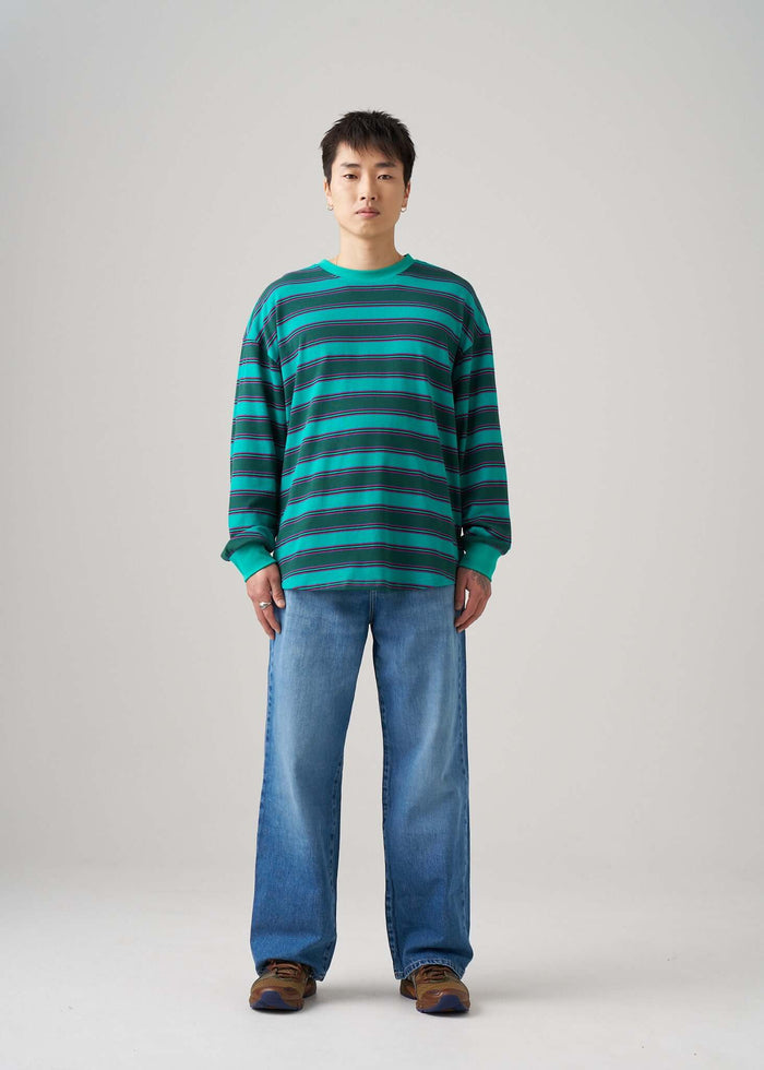 Long sleeve t-shirt in Emerald Drift pattern worn by a model with jeans and brown shoes.