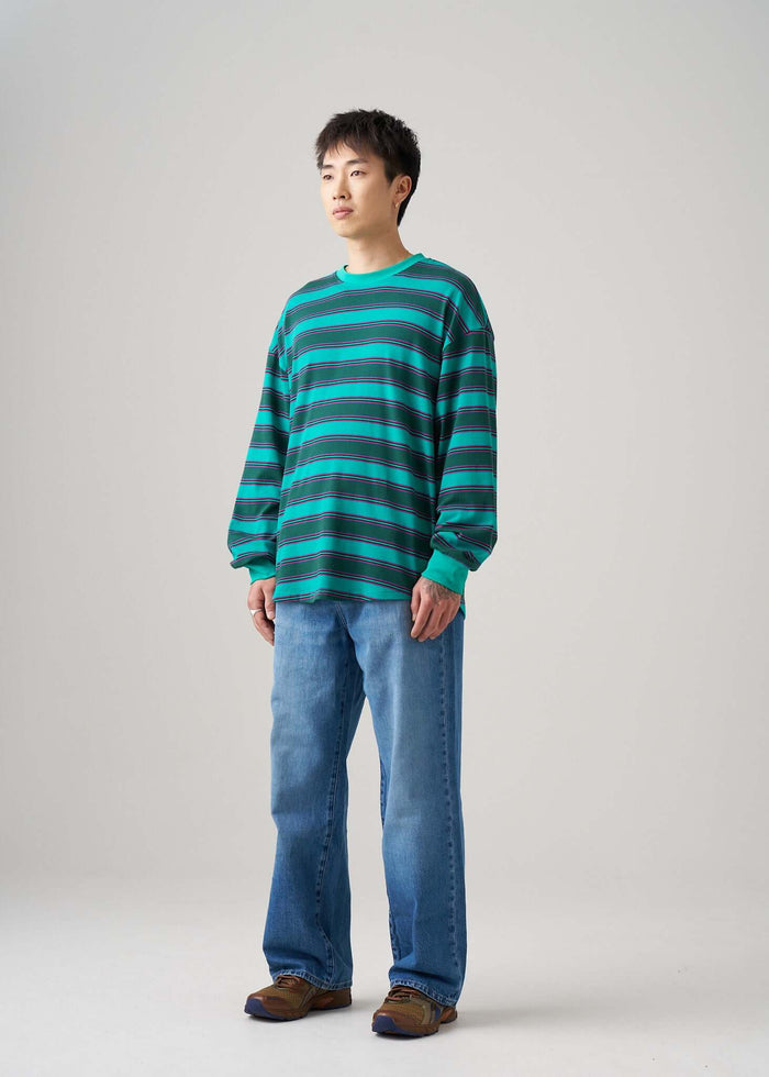 Long sleeve t-shirt in Emerald Drift pattern, worn with relaxed jeans for a casual look.