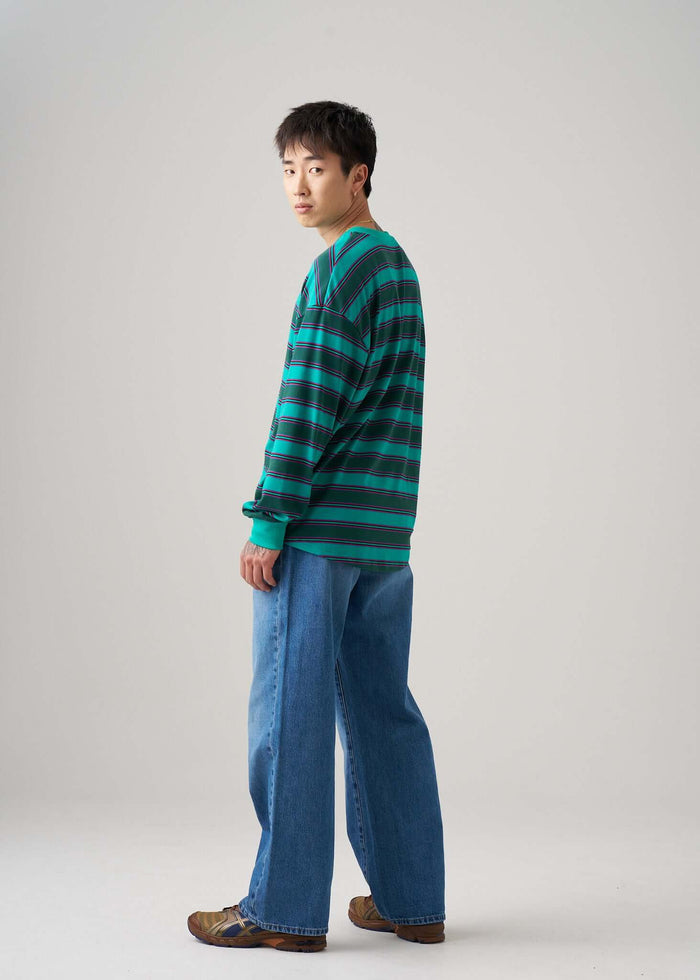 Long sleeve t-shirt in Emerald Drift pattern, worn by a model with relaxed fit jeans.