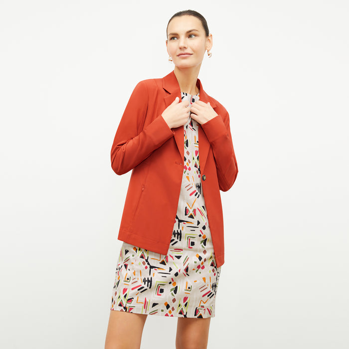 front image of a woman wearing the maaza dress in rhythm print