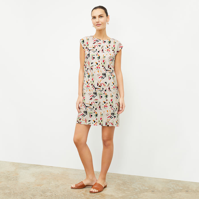 front image of a woman wearing the maaza dress in rhythm print