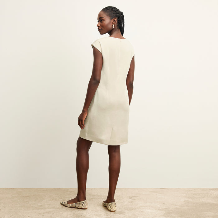 back image of a woman wearing the maaza dress in champagne