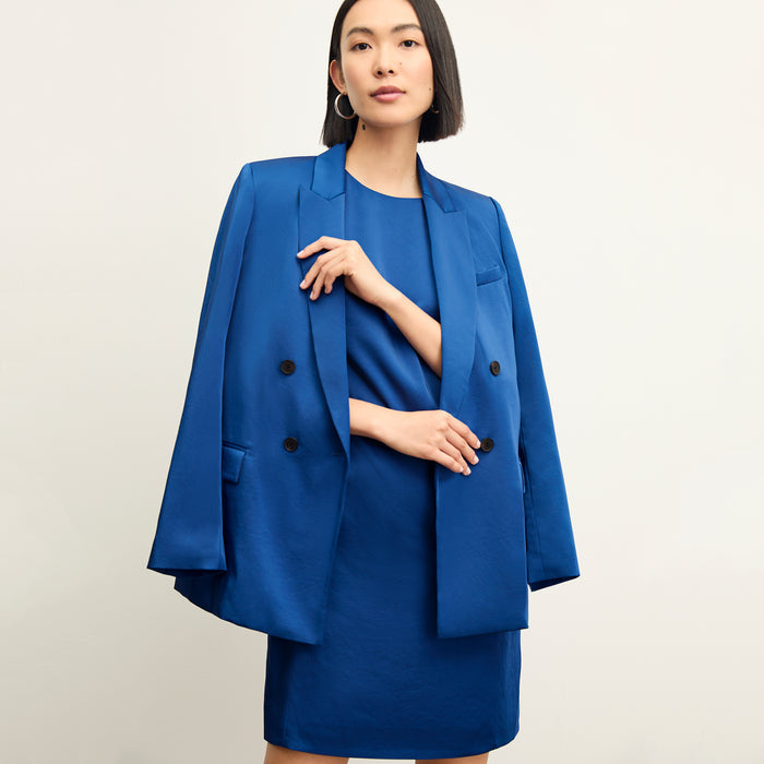 Front image of a woman wearing the maaza dress in sapphire