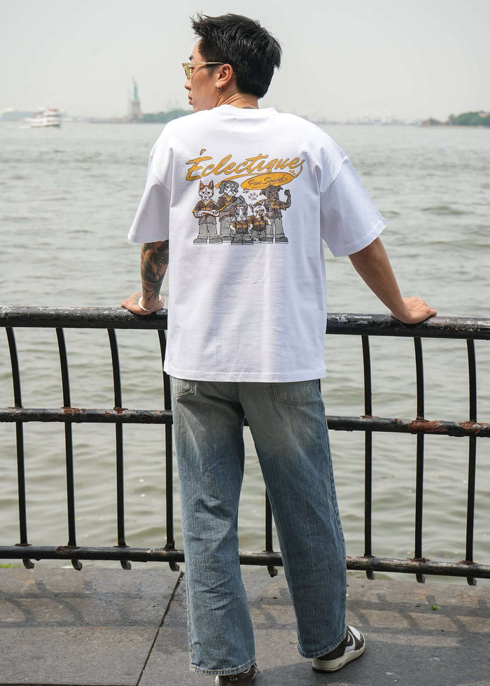 Men's Graphic T-shirt Paw Squad featuring unique design, worn casually by a man by the water.