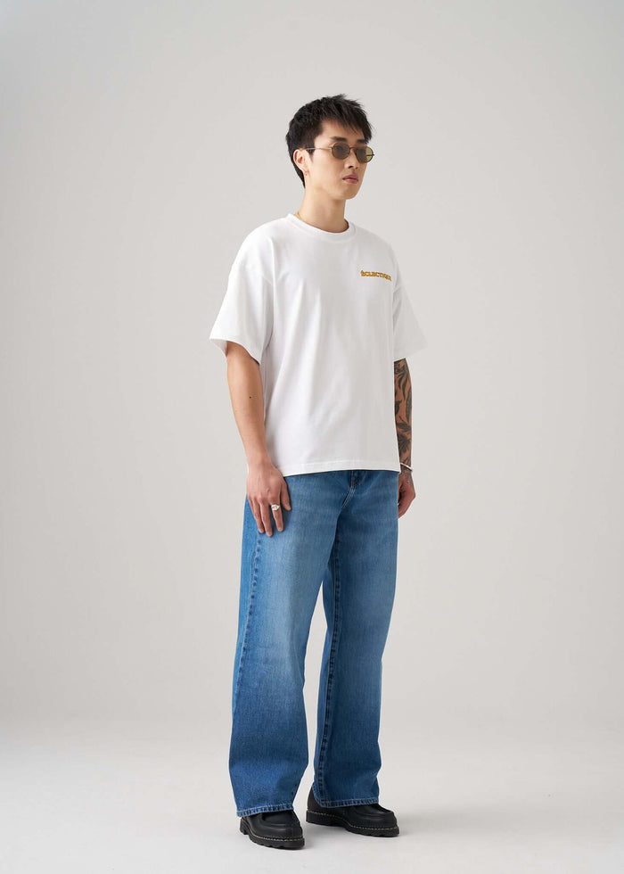 Men's Graphic T-shirt Paw Squad showcased by a model wearing casual jeans and sunglasses.