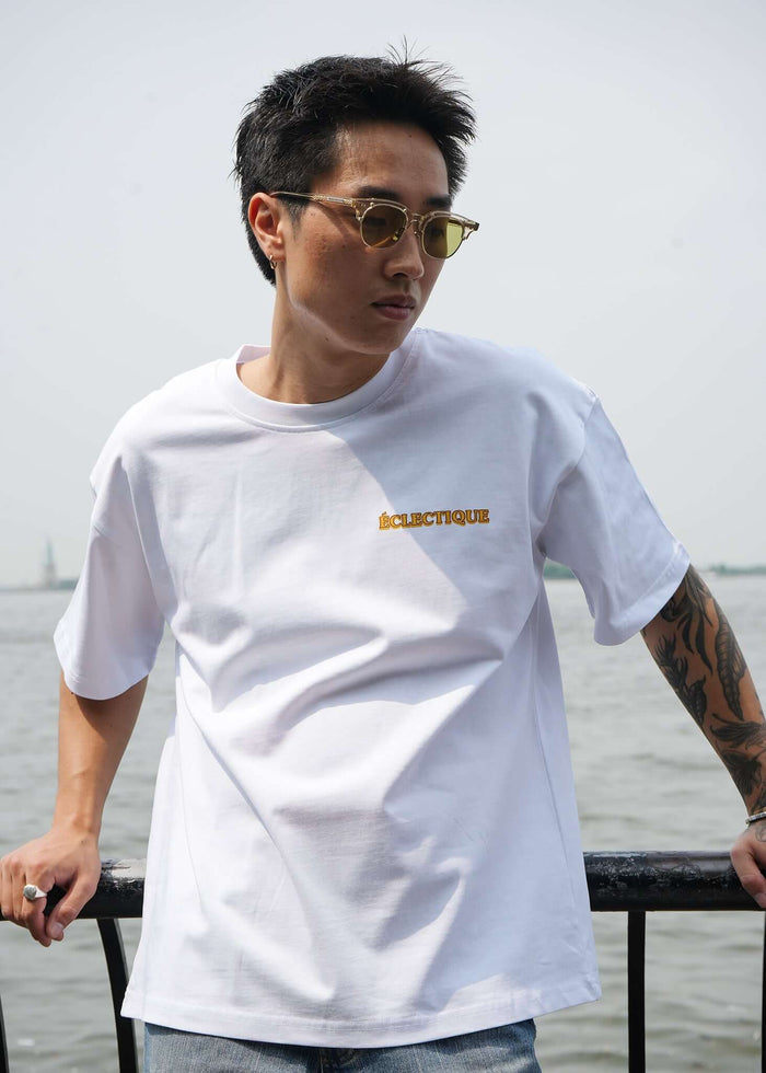 Men's Graphic T-shirt Paw Squad worn by a man in sunglasses at a waterfront, showcasing a modern design and relaxed fit.