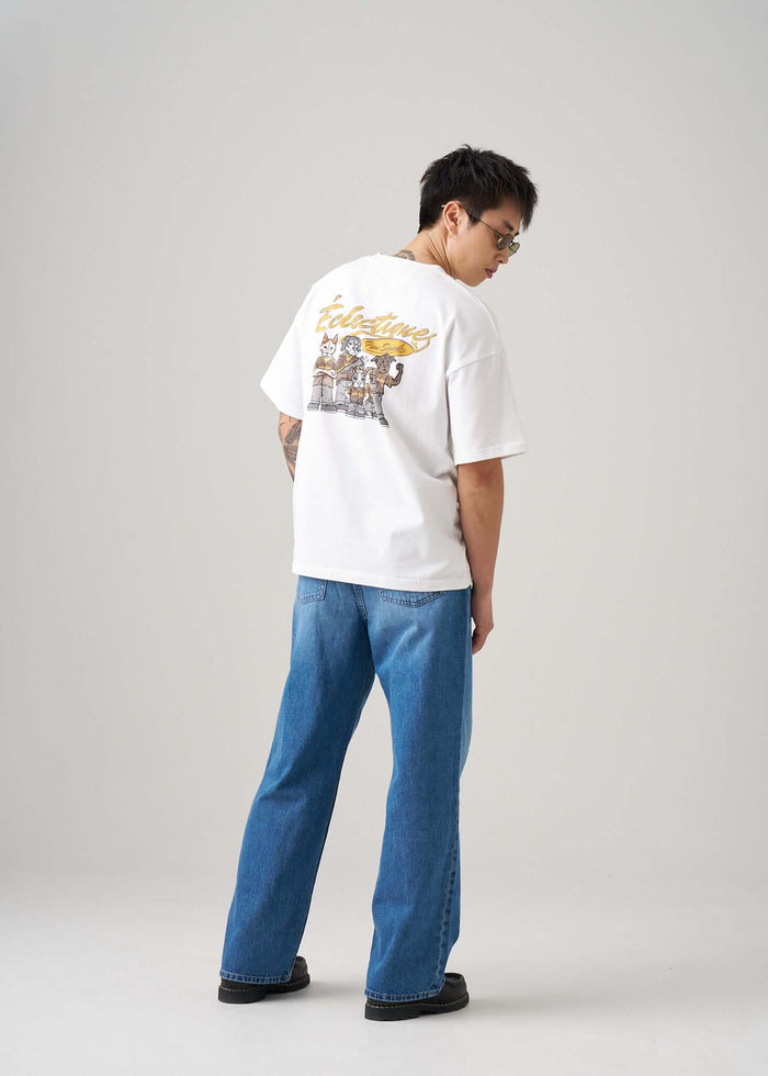 Men's Graphic T-shirt Paw Squad featuring a colorful print on back, styled with casual denim jeans.