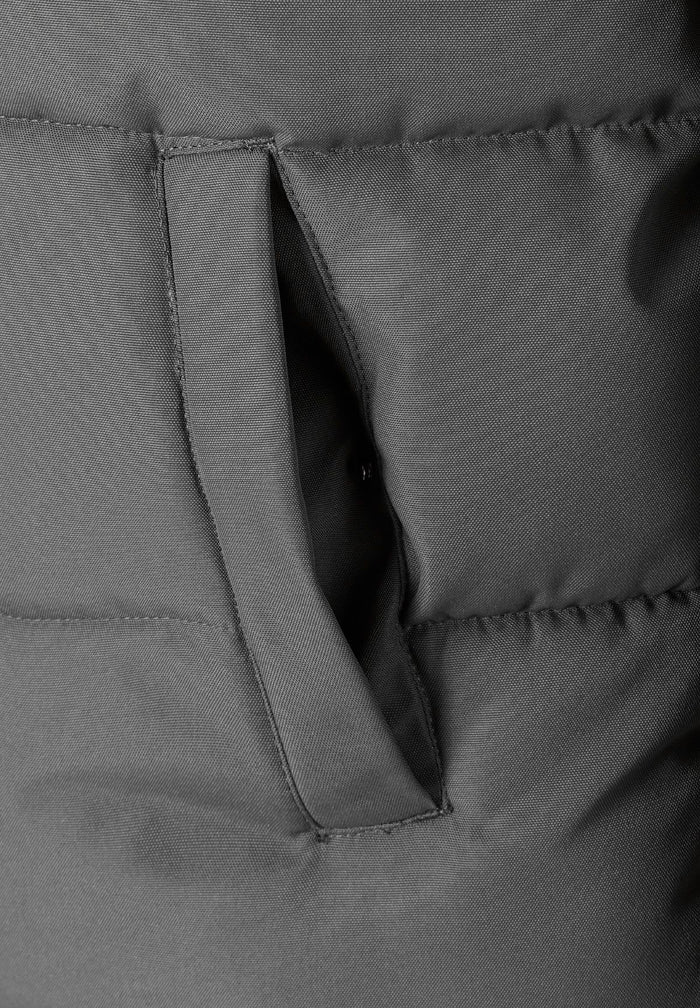 Detail of a men's padded jacket in grey, showing a zip chest pocket.
