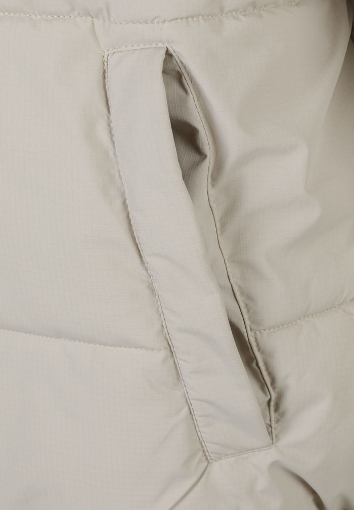 Detail of a men's grey ripstop jacket showing the pocket opening.