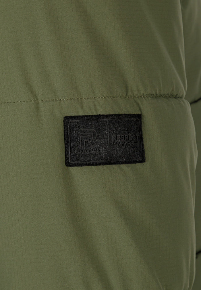 Detail of khaki men's ripstop jacket showing badge.