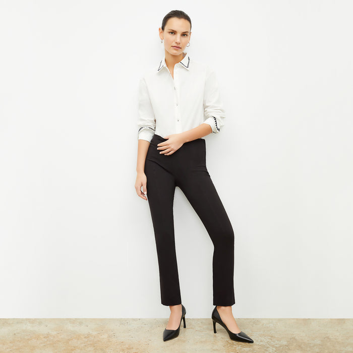 front image of a woman wearing the mila button down in white